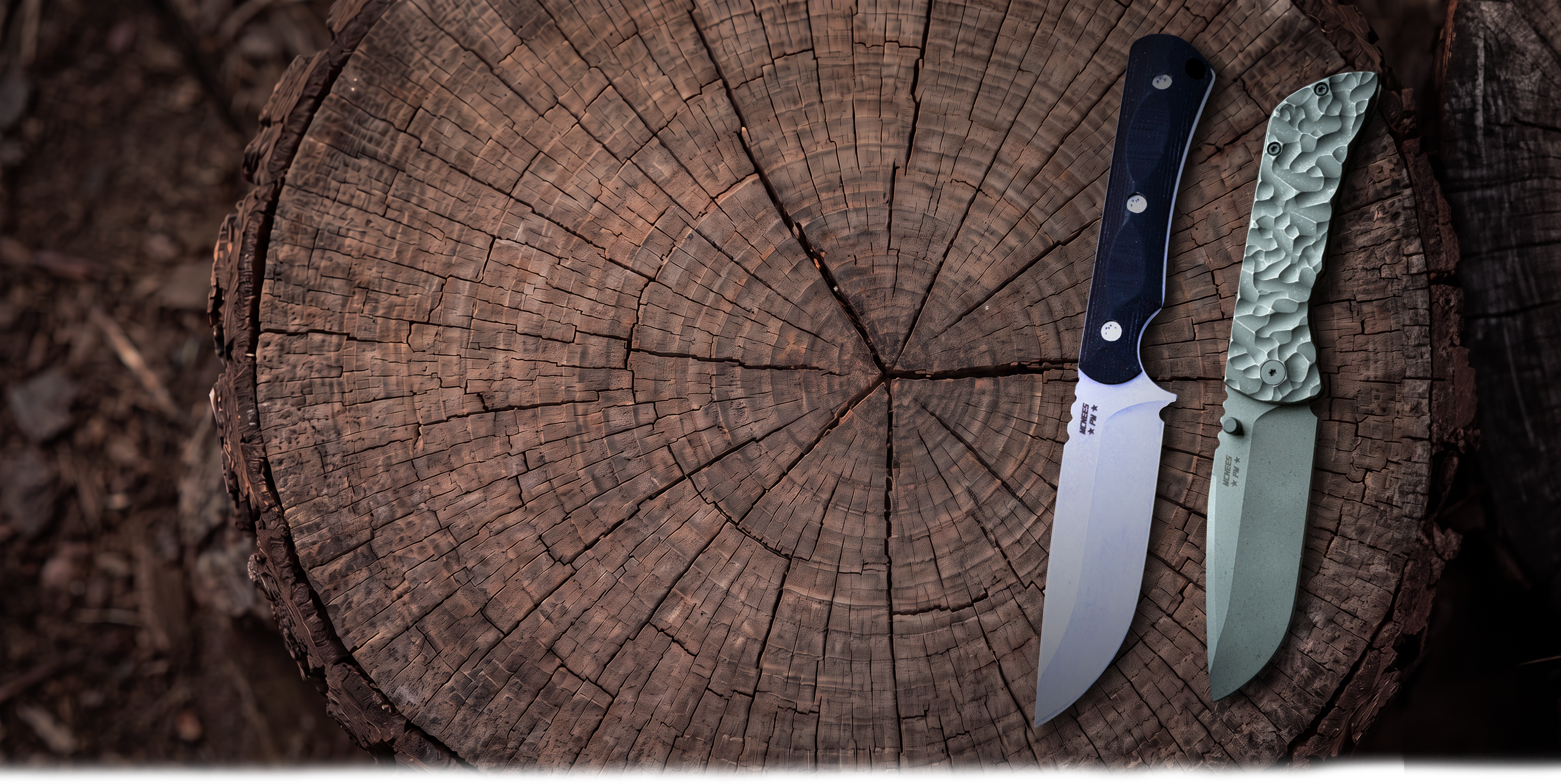 Two McNees knives on a stump