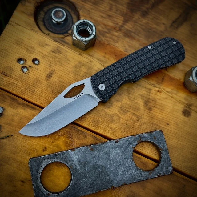 Stonewashed McNees folder on a stump